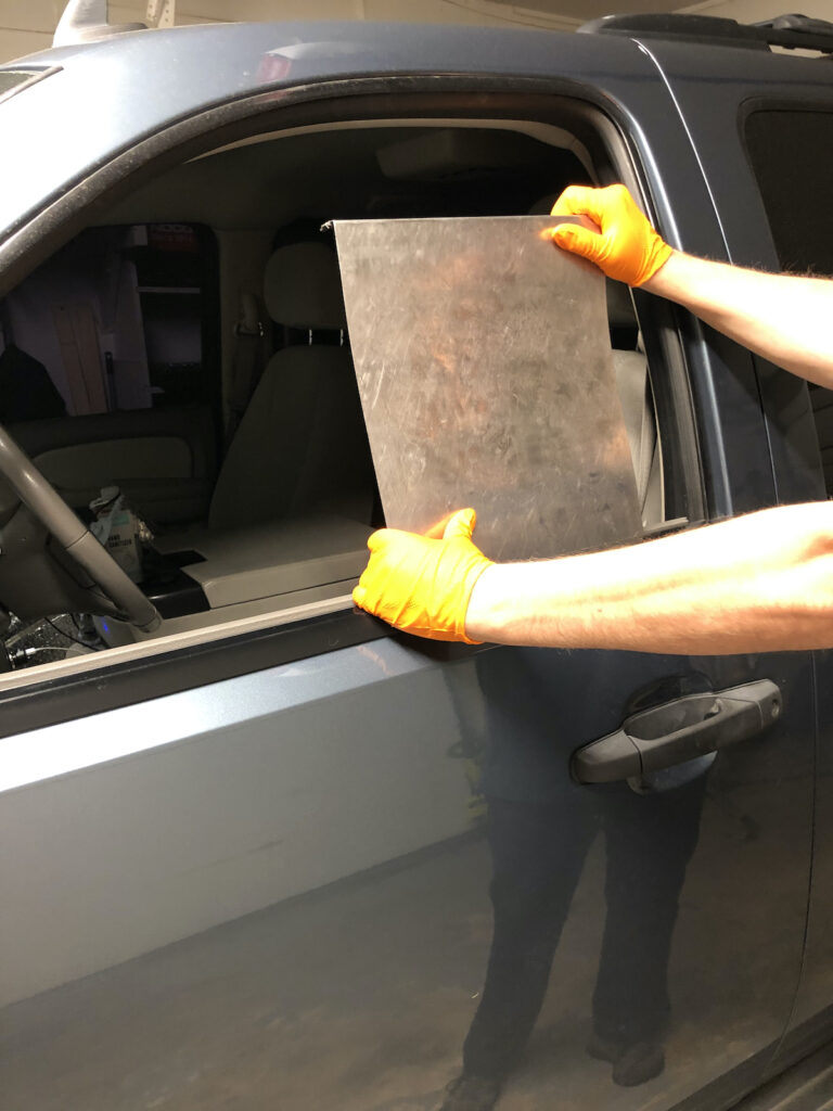 owner of lord of the dings showing how a technician would access a door panel to remove a door ding on a auto 