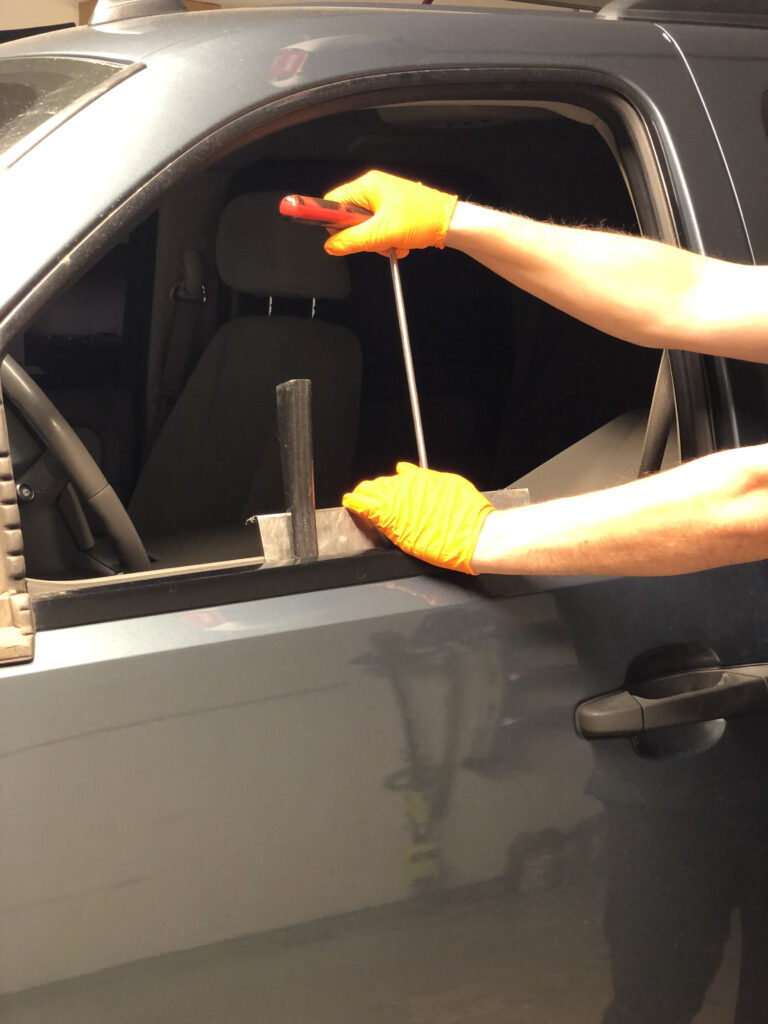 owner of lord of the dings showing what paintless dent repair tool that would be used to remove a dent on a door panel of a auto