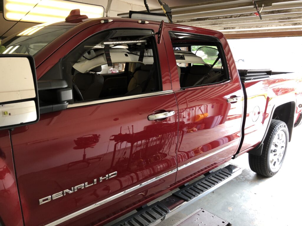 truck with headliner dropped to remove the hail dents in roof with paintless dent repair method